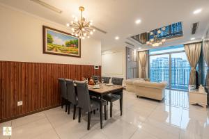 a dining room with a table and chairs at The Regal Residence at Vinhomes in Ho Chi Minh City
