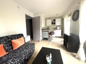 a living room with a couch and a table at Studio bord de mer in Fréjus