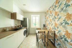 a kitchen with a table and a dining room at L'Echapée Belle en Val de Saône in Saint-Didier-sur-Chalaronne +17 photos