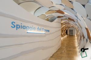 a hallway of a tunnel with a sign on the wall at HOTIDAY Room Collection - Mattinata Faraglioni in Mattinata