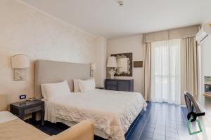 a hotel room with a bed and a window at HOTIDAY Room Collection - Mattinata Faraglioni in Mattinata