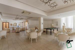 a living room with a ping pong table and chairs at HOTIDAY Room Collection - Mattinata Faraglioni in Mattinata