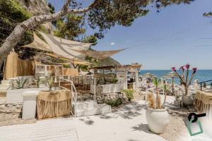 a beach wedding with tables and chairs and the ocean at HOTIDAY Room Collection - Mattinata Faraglioni in Mattinata