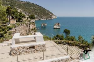 a view of the ocean from a house at HOTIDAY Room Collection - Mattinata Faraglioni in Mattinata