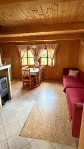 a room with a bed and a table and a fireplace at Bungalovy Baranec in Žiar