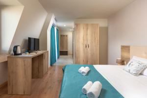 a bedroom with a bed with towels on it at Sea View Hills in Sveti Vlas