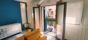 a living room with a couch and a large window at Blu House in Chioggia +5 photos