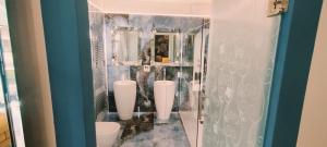 a bathroom with three urinals on the wall at Blu House in Chioggia