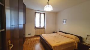 a bedroom with a bed and a window at Campione - Garda Wind Apartment 2 bedrooms in Campione del Garda