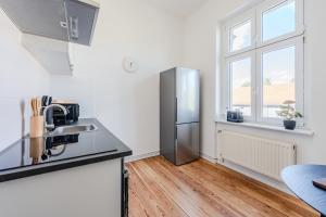 a kitchen with a stainless steel refrigerator and a window at Cozy 1BR - Family Retreat in Potsdam! in Potsdam +6 photos