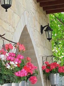 a stairway with flowers in buckets and lights at Magdalous House in Arsos