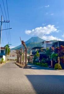 a street with palm trees on the side of a road at Villa Mecca in Batu