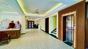 two men standing in a hallway of a hotel at Hotel Sagar haveli Bikaner in Bikaner