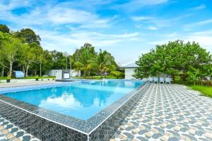 an image of a swimming pool at a house at Hotel O Asiacamp Chalet Tanjung Karang in Kuala Selangor