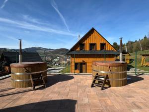 two barrels sitting in front of a building at Penzión Uhliská in Nižná +17 photos