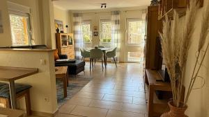 a living room with a table and a dining room at Zempin Ostseepark WE 10 _Insel Use in Zempin