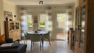 a kitchen with a table and chairs in a room at Zempin Ostseepark WE 10 _Insel Use in Zempin +11 photos