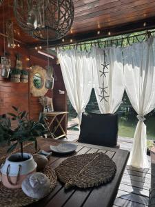 a wooden table with dishes on it in a room at KaSper River House in Ledine