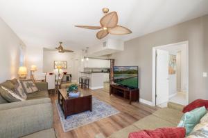 a living room with a couch and a tv at Ko Olina Kai 1059F in Kapolei