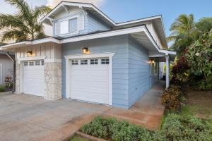 a house with white garage doors on a driveway at Ko Olina Kai 1059F in Kapolei
