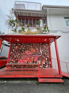 a red bench in front of a building at The Harbour by Moonknight in George Town