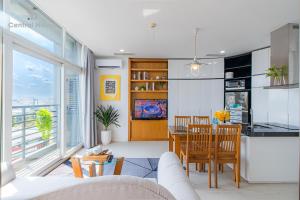 a kitchen and living room with a table and chairs at The One Sai Gon in Ho Chi Minh City