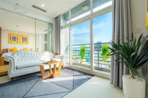 a living room with a couch and a large window at The One Sai Gon in Ho Chi Minh City +188 photos