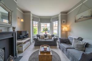 a living room with a couch and a fireplace at Danes House 4 in Aldeburgh
