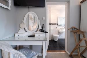 a bathroom with a white vanity and a mirror at Danes House 4 in Aldeburgh +36 photos