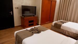 Łóżko lub łóżka w pokoju w obiekcie Le Park Hotel