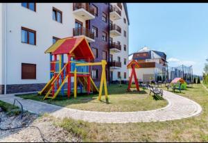 a playground in front of a apartment building at J&M Apartman Zlatibor in Zlatibor