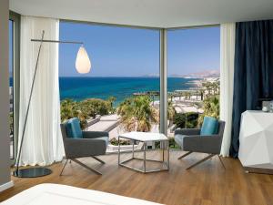 a living room with a view of the ocean at Swissôtel Resort Bodrum Beach in Turgutreis