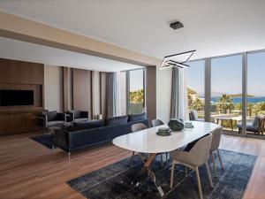 a living room with a table and a couch at Swissôtel Resort Bodrum Beach in Turgutreis