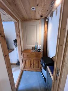 an interior view of a tiny house with a wooden cabinet at ÉTAPE Chambre 2 pers indépendante idéale avant ou après votre séjour en station in Aime La Plagne