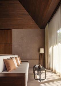 a bedroom with a bed and a table at One&Only Mandarina in Lo de Marcos