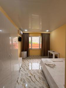a large room with a bed and a glass wall at R Hotel Yerevan in Yerevan +6 photos