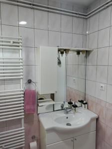 a white bathroom with a sink and a toilet at Luni in Travnik +12 photos