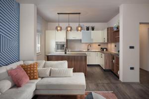 a living room with a couch and a kitchen at Villa Veg in Umag