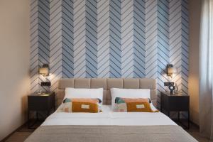 a bedroom with a bed and a blue and white wall at Villa Veg in Umag +17 photos