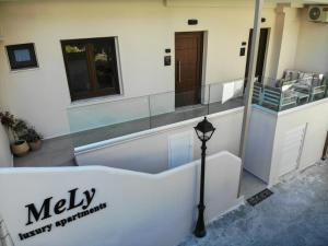 a building with a sign that says meily therapy department at Mely Luxury Apartments in Parga