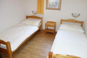 two twin beds in a room with a window at Pracondu 2 406 - OUTDOOR & FUN apartment 6 pers in Nendaz