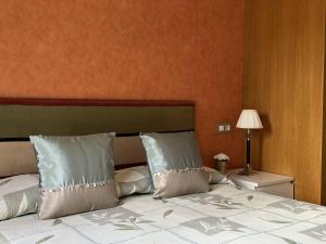 a bedroom with a large bed with white pillows at El Mirador del Orfanato 1C in Llanes