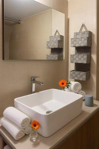 um banheiro com pia branca e espelho em Lovingly apartment Galatsi 1 em Atenas