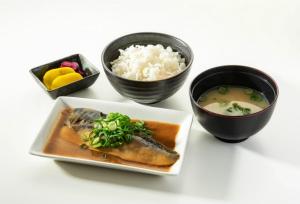 a plate of food with rice and a bowl of soup at ホテルジップスタイル in Sendohira