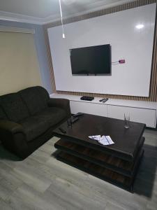 a living room with a couch and a coffee table at Emakhonkosi Guest House in Ballito