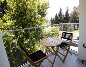 a balcony with a table and two chairs on a balcony at Alpesa Apartments in Budva
