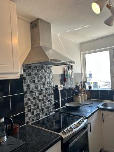 a kitchen with a stove top oven in a kitchen at Cosy flat by Penzance harbour in Penzance +15 photos