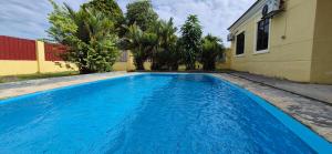 a large blue swimming pool next to a building at Striatus by Holiday Pool Villa A'Famosa Resort in Gua Sai