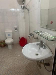 a bathroom with a sink and a toilet at Nhà nghỉ Dung Hoà in Ha Long