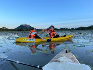 two people in a yellow kayak on a lake at Royal Breeze Resort Sigiriya in Sigiriya